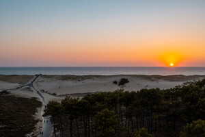 Coucher de soleil sur la promenade vers la plage du camping 5 étoiles Le Vieux Port dans les Landes